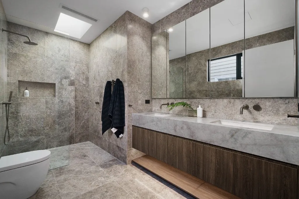 Custom bathroom vanity with marble benchtop and mirrored cabinet