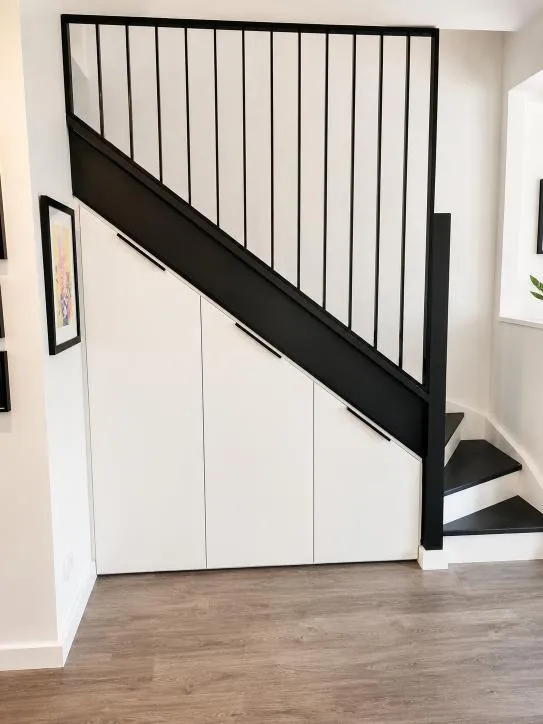 Under-stair cabinetry with black staircase