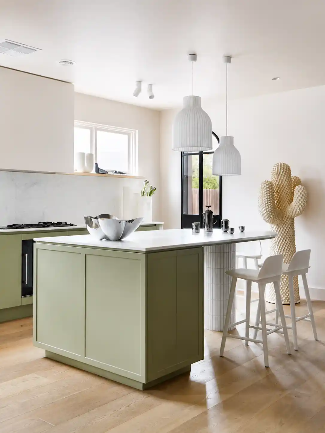 Sage island with stone top and pendant lighting
