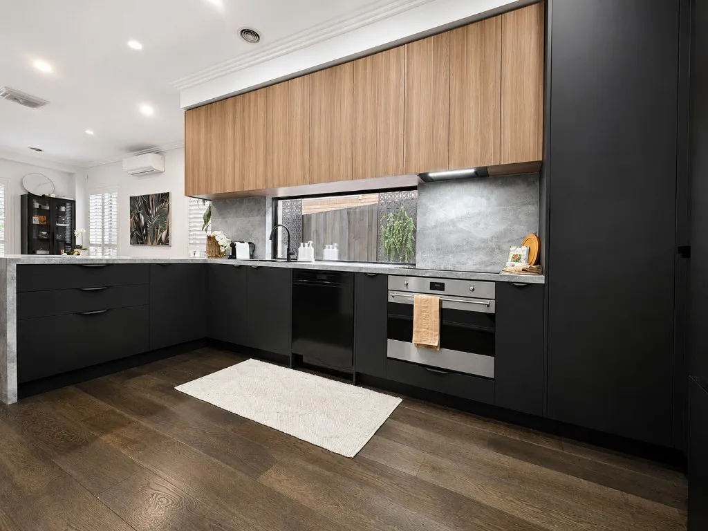 Black and timber kitchen with stone benchtop