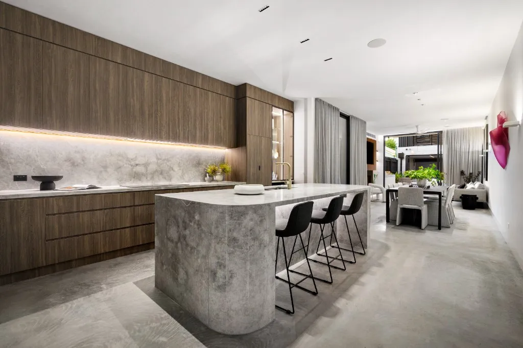 Timber kitchen with stone island and concrete floor