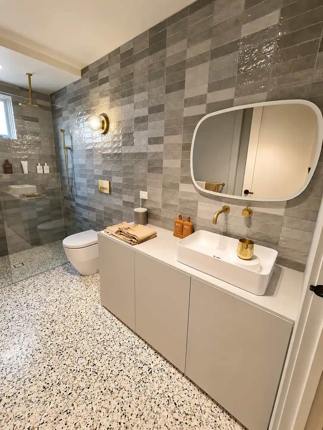 Stone-top vanity with brushed brass fittings