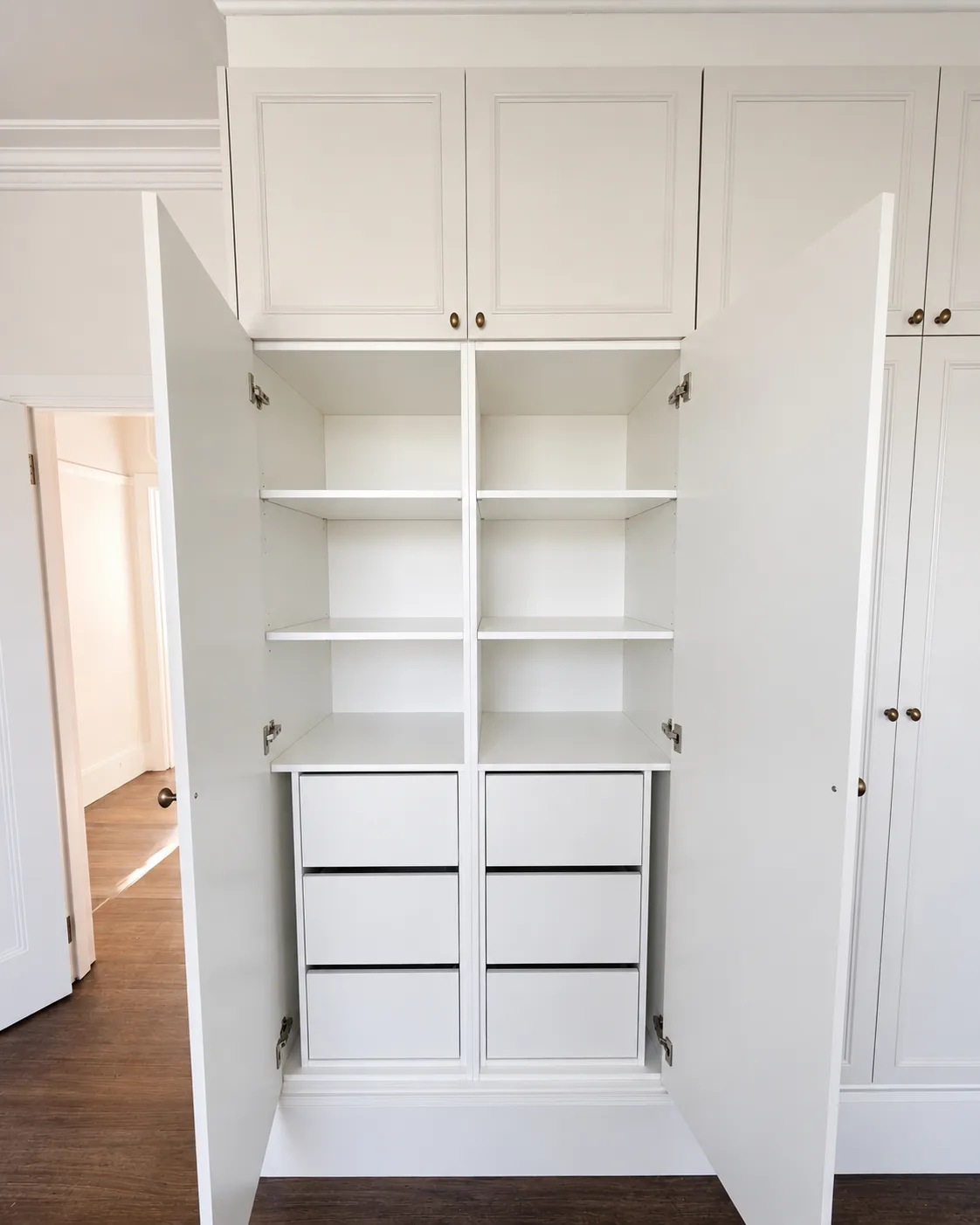 Open drawer with timber dividers and folded clothing