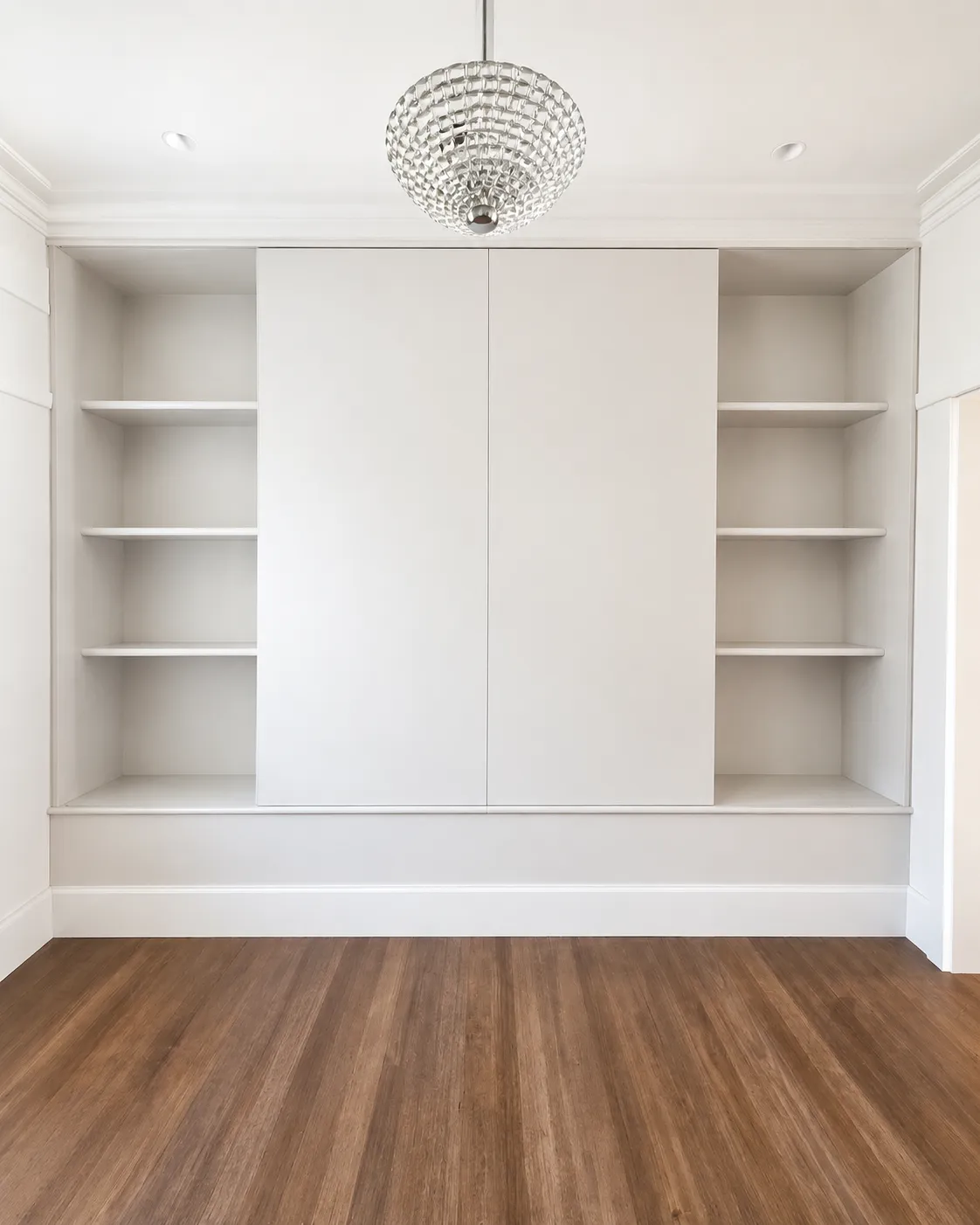 Built-in wall unit with sliding doors and open shelving